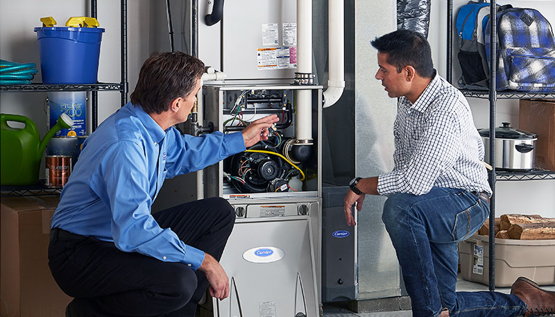 HVAC technician evaluating a furnace for repair or replacement in Ogden