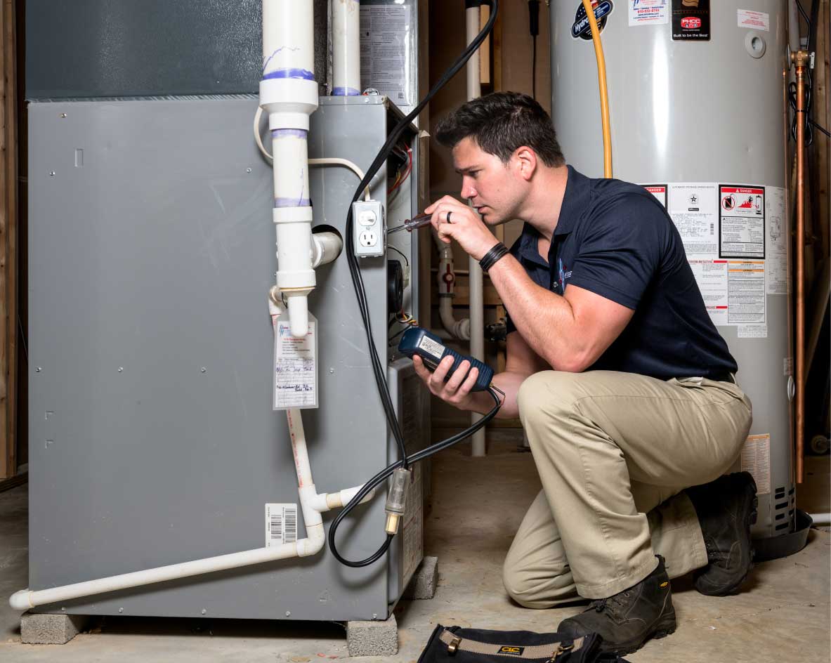 HVAC technician performing a furnace tune-up in Ogden