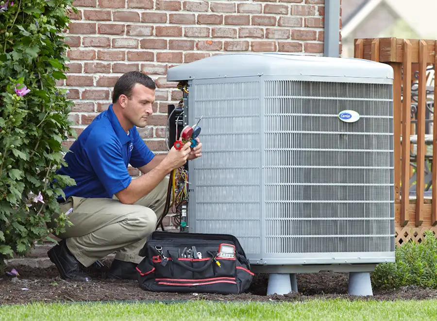 HVAC technician inspecting an outdoor air conditioning unit in Ogden